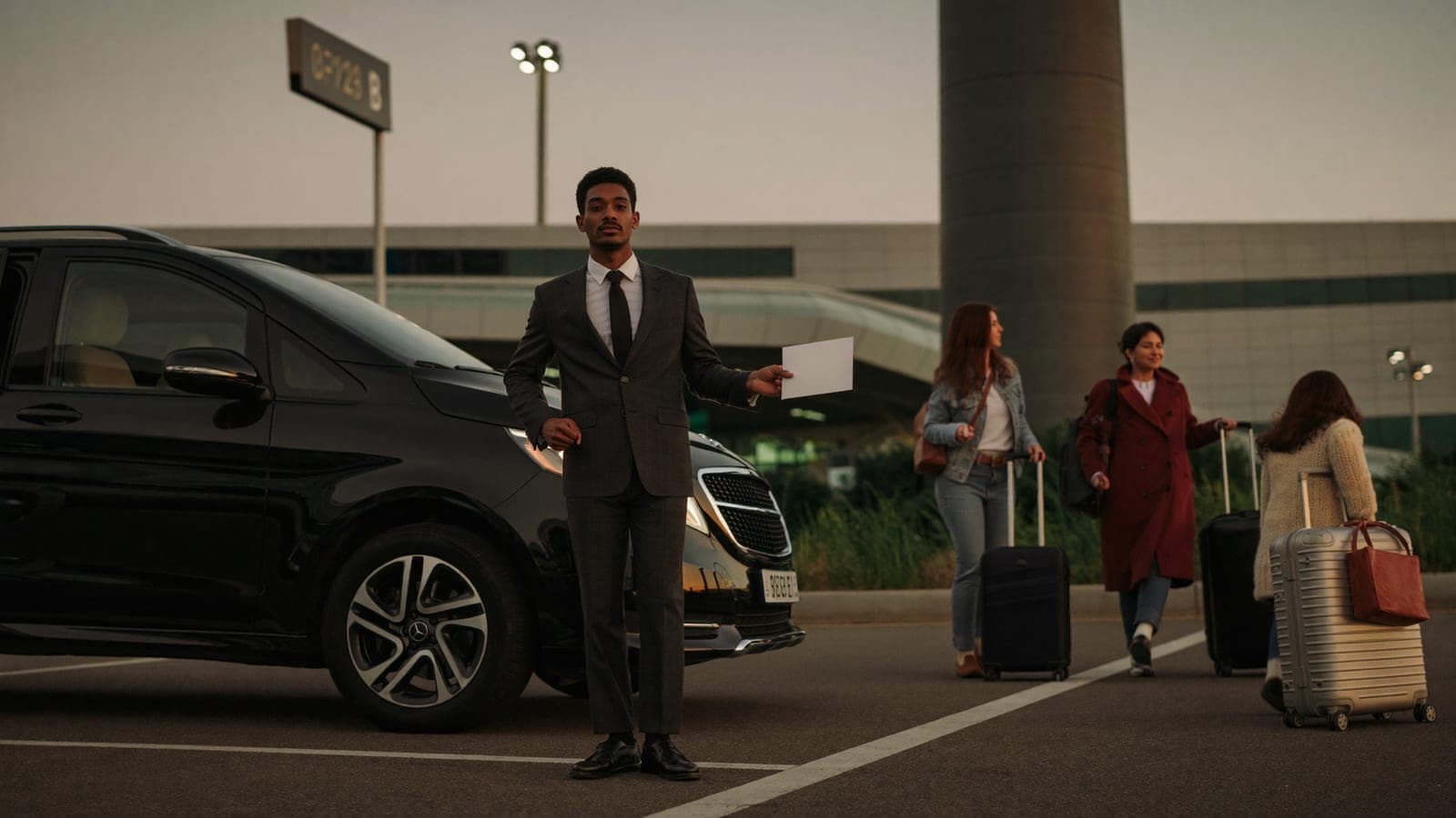 KAR GO Mercedes V-Class private transfer at Orly airport — driver with name sign meeting family