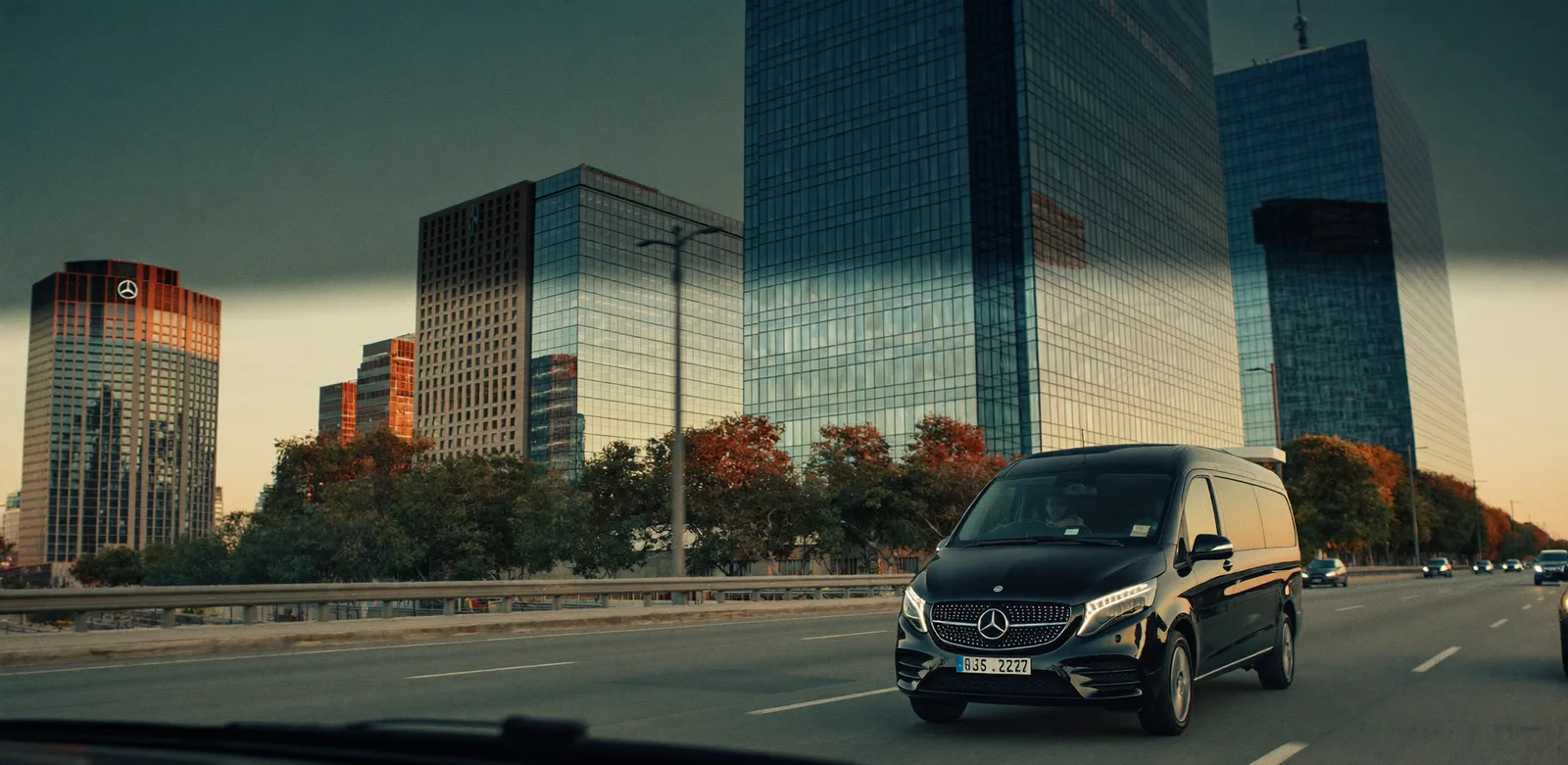 Chauffeured Mercedes van arriving at a Paris business district office