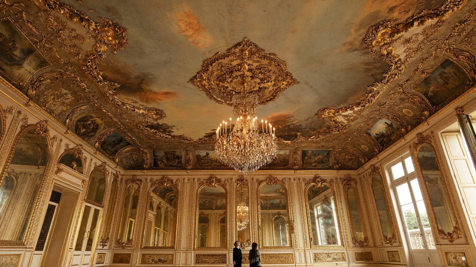 Hall of Mirrors Palace of Versailles gilded ceiling chandeliers children looking up